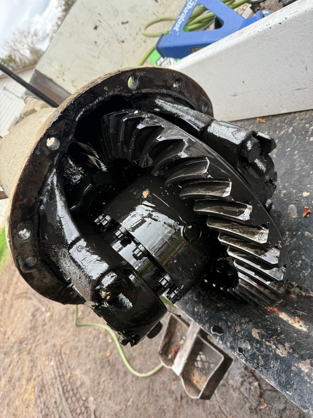 Close-up of a mechanical differential assembly, showcasing gears and lubrication.