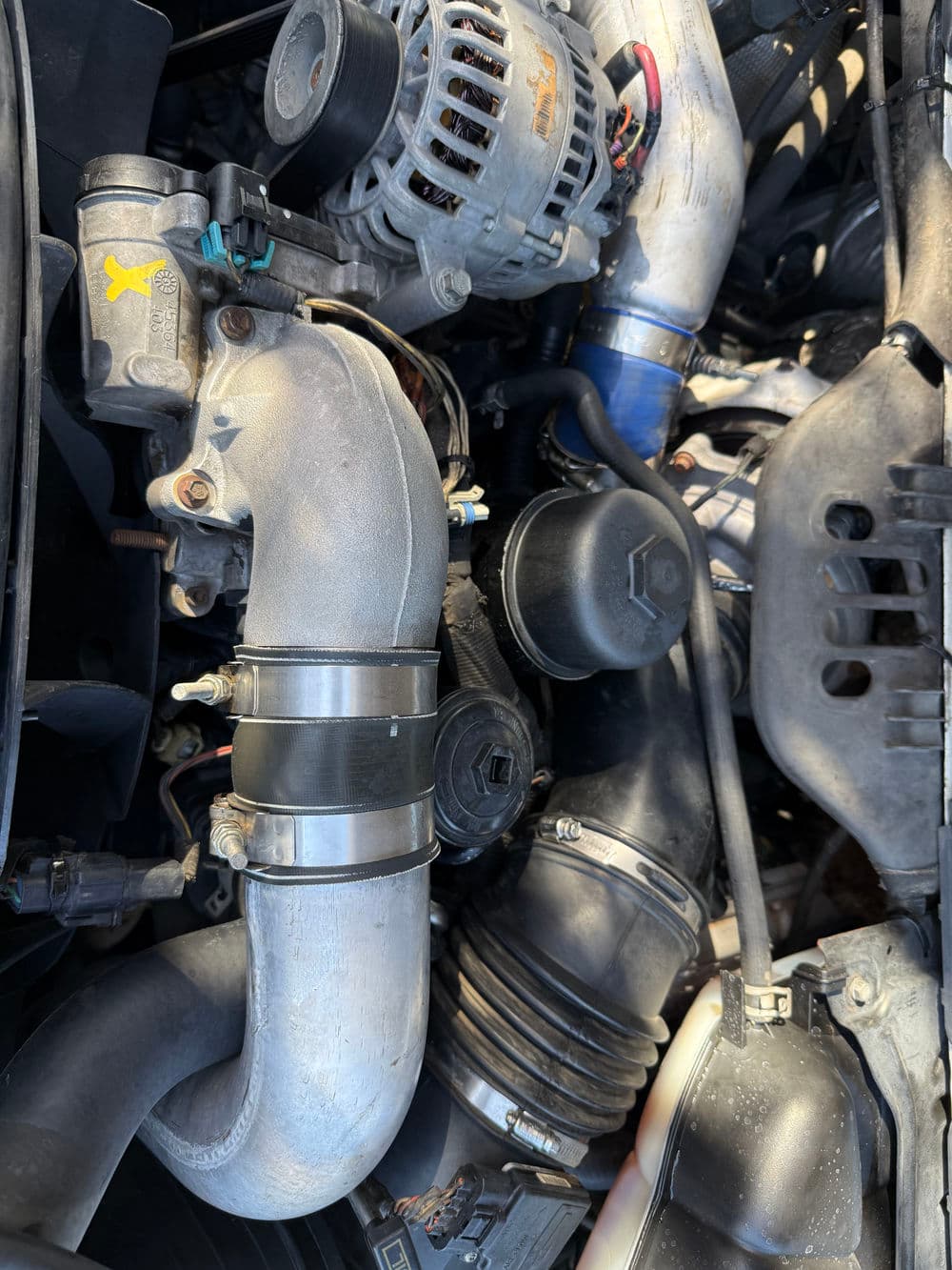 Detailed view of a car engine with turbocharger, air intake system, and electrical components.
