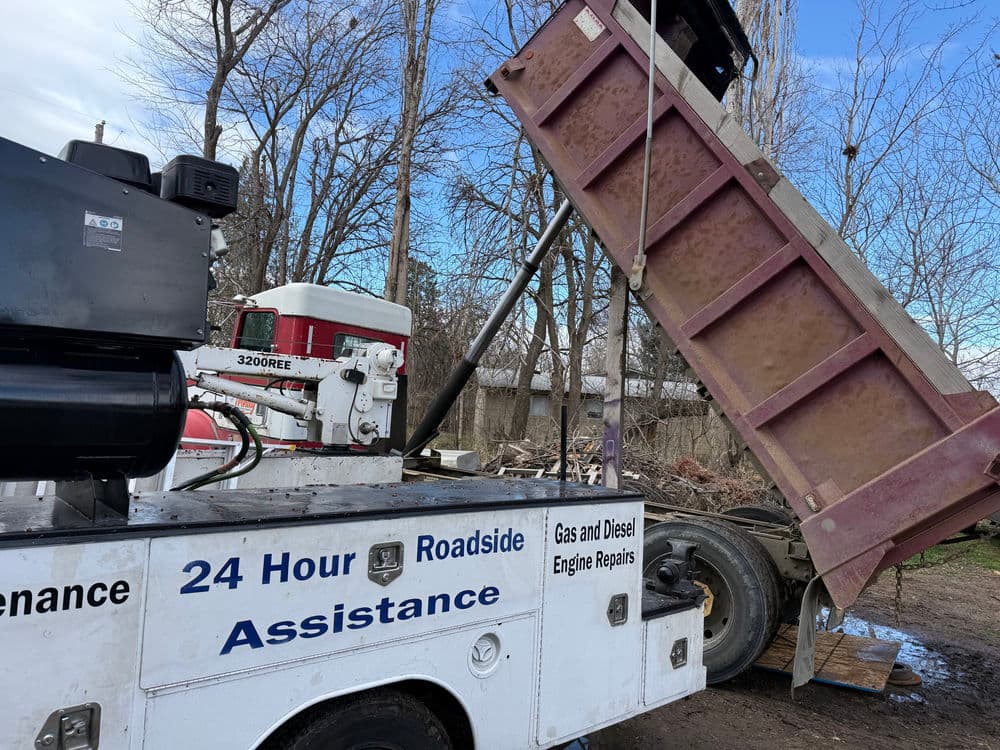 24-hour roadside assistance truck unloading equipment for gas and diesel engine repairs.