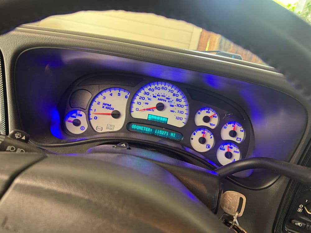 Car dashboard with illuminated gauges and odometer reading 118,271 miles.